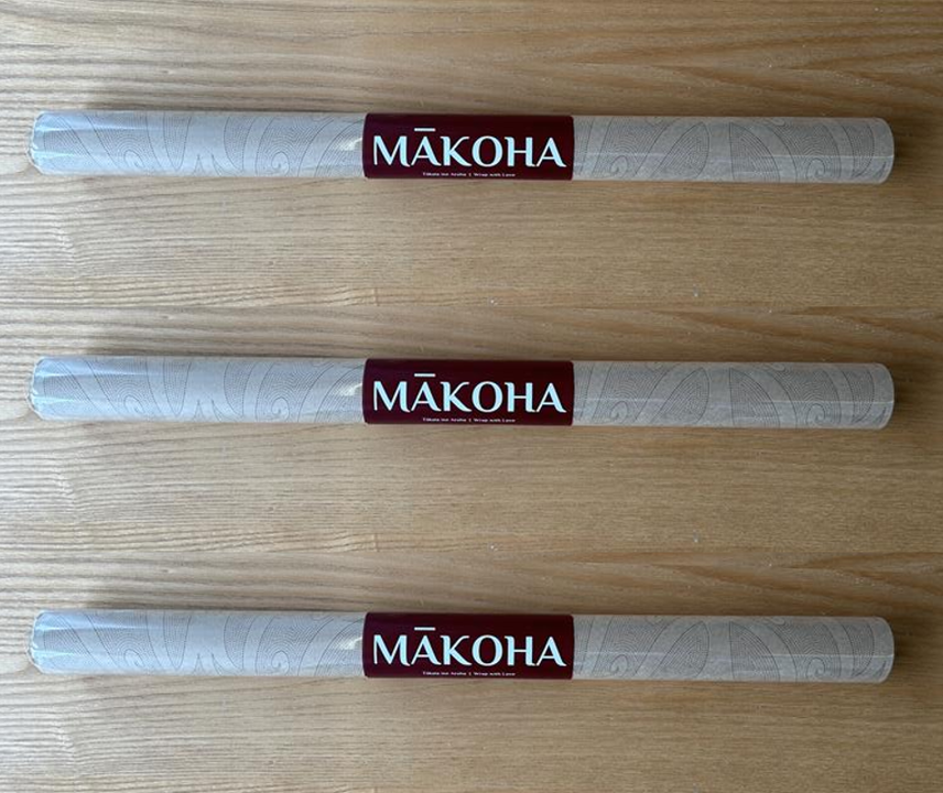 Three Makoha maori wrapping paper on a wooden surface